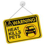 Photo of a sign reading Warning, Heat kills pets