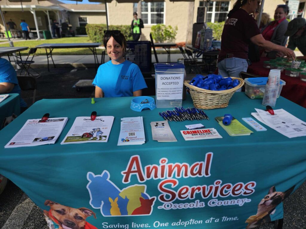 Animal Services volunteer at a table